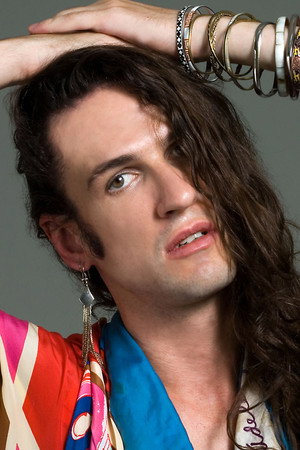Dudu Bertholini in Tie and Red Nail